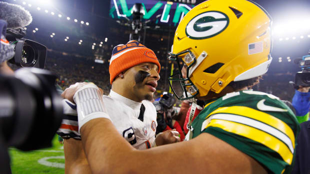 Justin Fields talks with Jordan Love after the Packers won the finale.